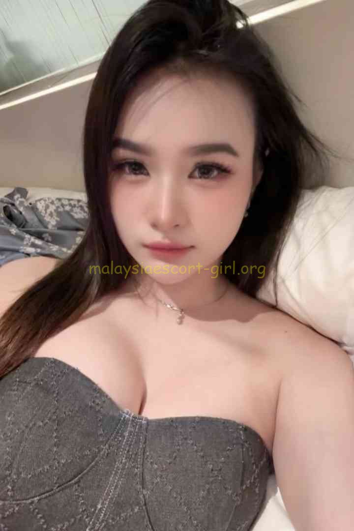 Woman with long dark hair wearing a strapless top.