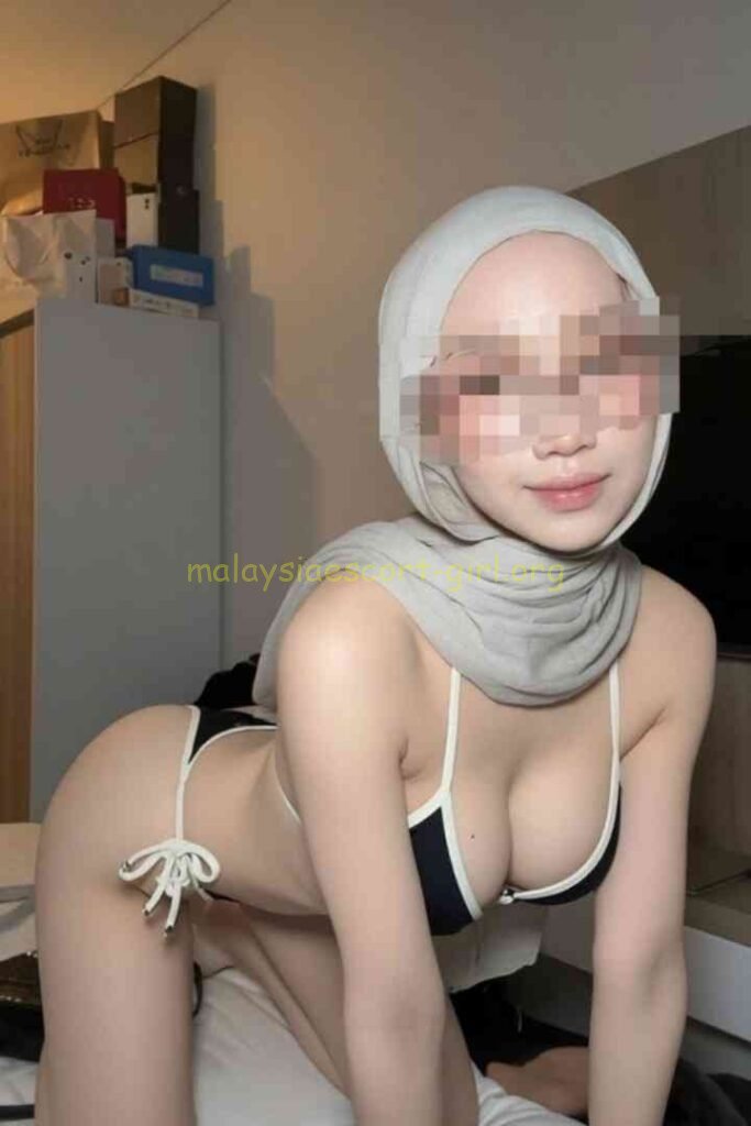 Kesya, a Malaysia Escort, wearing a hijab and bikini, smiling for the camera